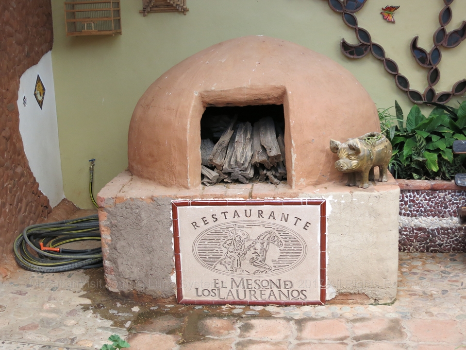 A display of cured local ingredients and spice strings inside the entry hall