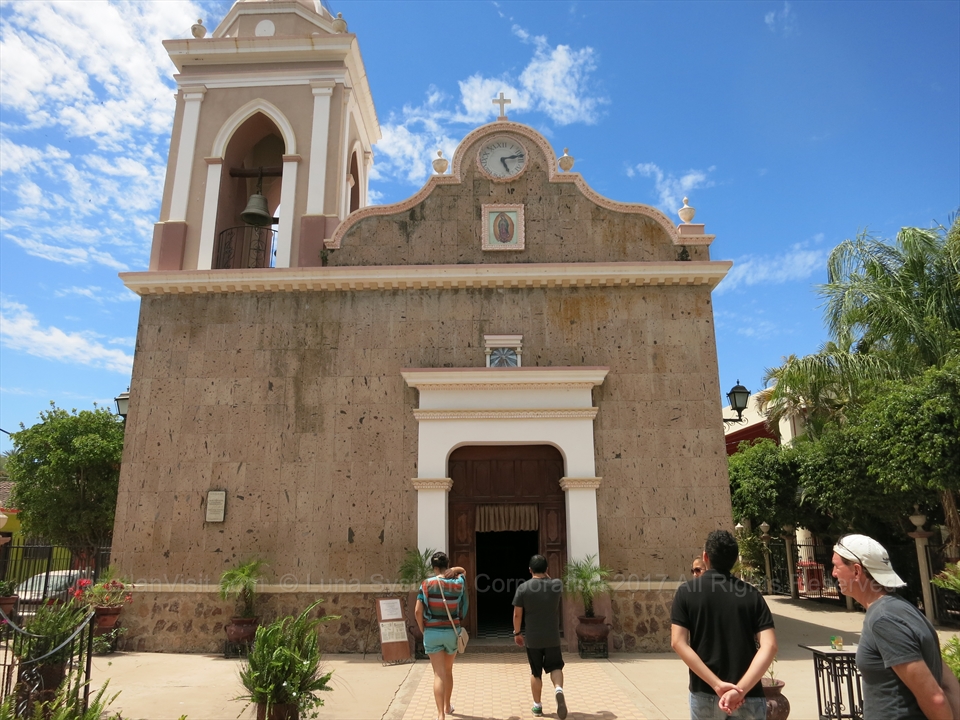 The front facade of a historic pastel colored home in El Quelite
