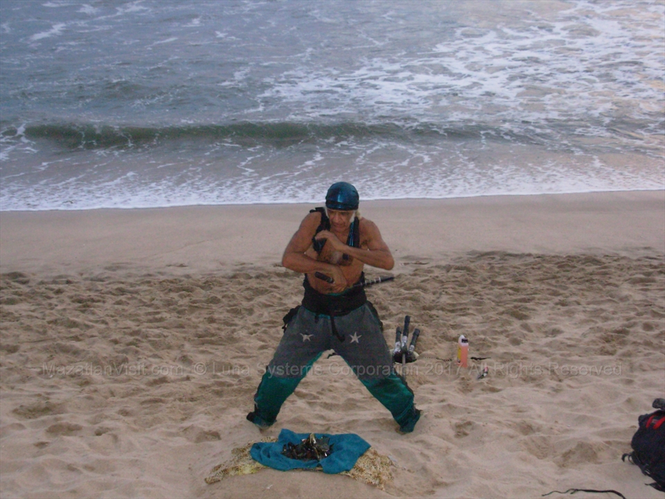 José performing an intense martial arts exhibition on the sand