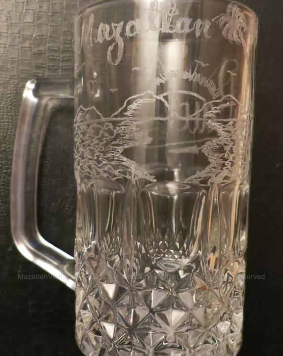 An intricately engraved glass mug featuring a personalized design by Jose