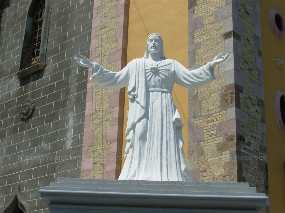 The marble statue of the Virgin Mary standing inside a protective side altar recess