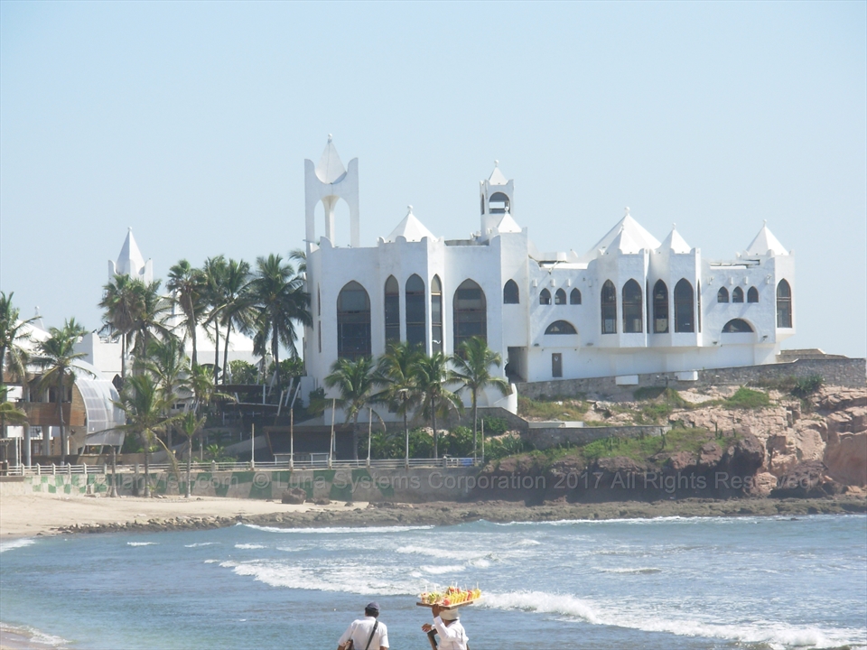 The iconic white castle structure of Punto Valentino sitting on a rocky ocean point