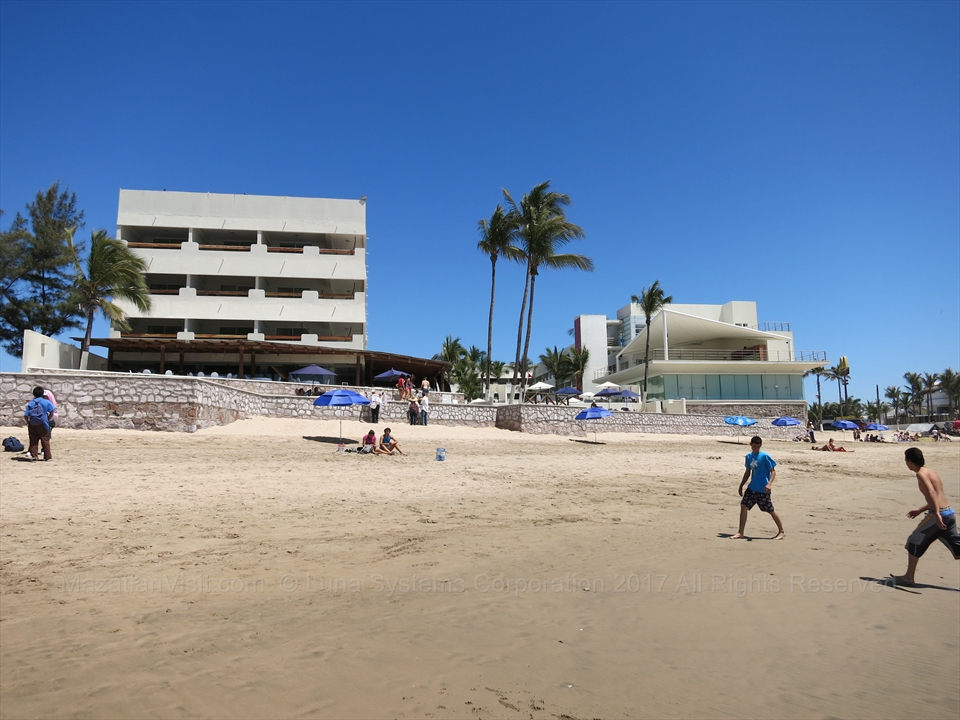 The tall geometric white towers of Hotel Emporio right on the beach