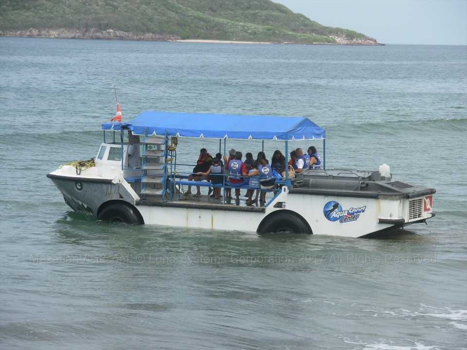 Tourists boarding an open air panga boat for a guided day excursion