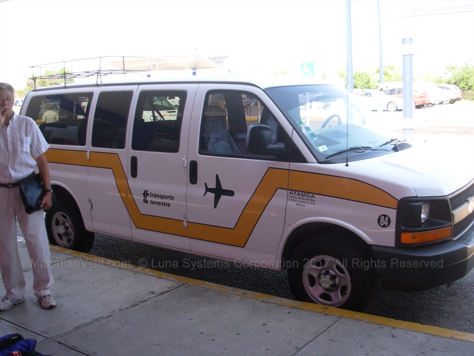 Authorized shared collective shuttle vans picking up travelers at Mazatlán Airport
