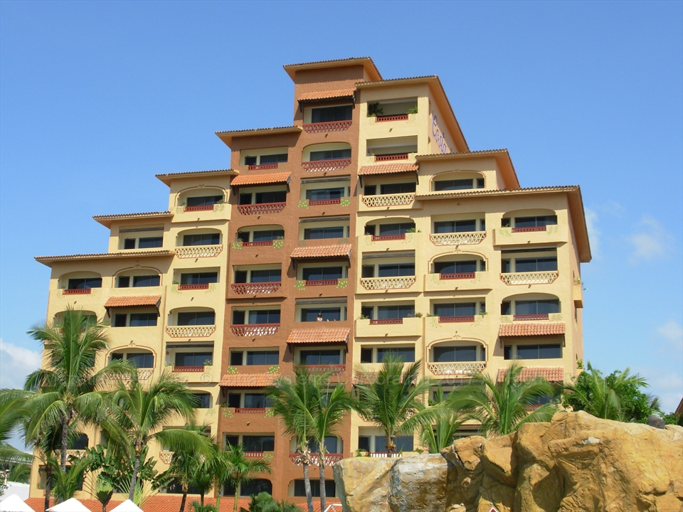 Palm trees swaying over a timeshare pool resort deck in Mazatlán