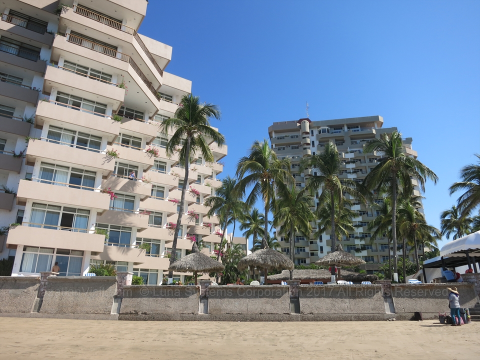The central swimming pool structures and palm tree gardens of Sunvivia by Fiesta Americana Mazatlán