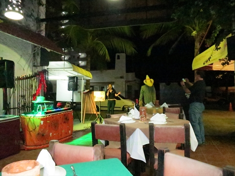 Anglers and travelers participating in a lively crowded karaoke session at Margaritas