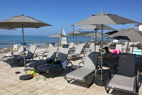 The large ocean-facing infinity pool and deck loungers
