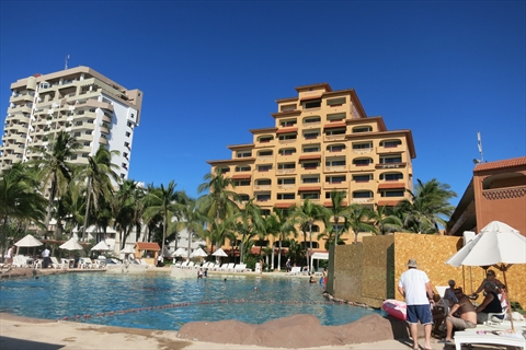 Large swimming pool terraces of Hotel Costa De Oro bordering the sandy shoreline