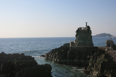 A brave local cliff diver jumping off the high platform into the breaking waves at Olas Altas