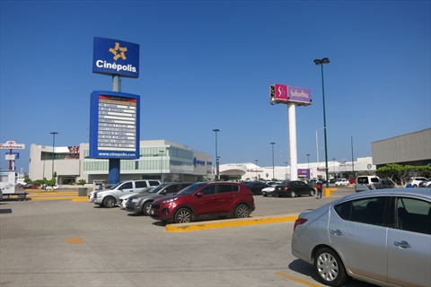 The front entrance neon signs of a large shopping mall complex housing a cinema