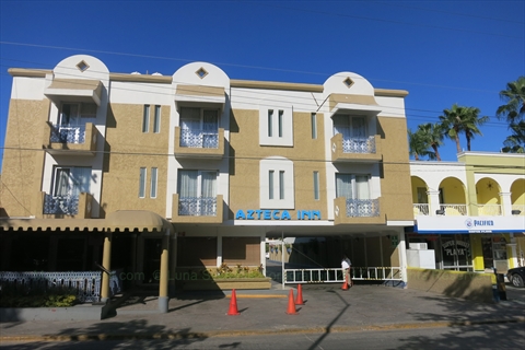 The front neon sign of Hotel Azteca Inn