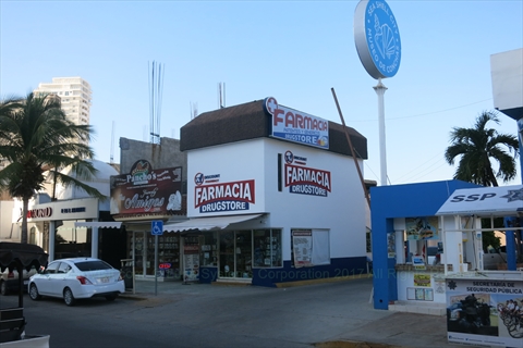 A well lit modern Farmacia storefront with prescription counters