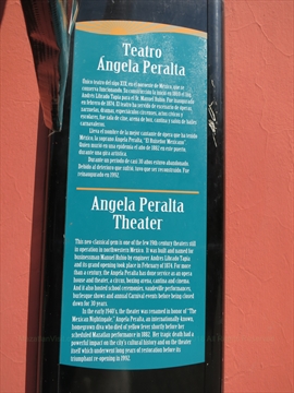 Close up shot of the official bronze historical overview plaque mounted on the interior theater walls