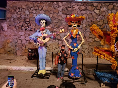 Catrina facepaint models presenting elegant floral dresses