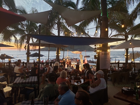 The Brenster performing live with his acoustic guitar on the beachfront stage