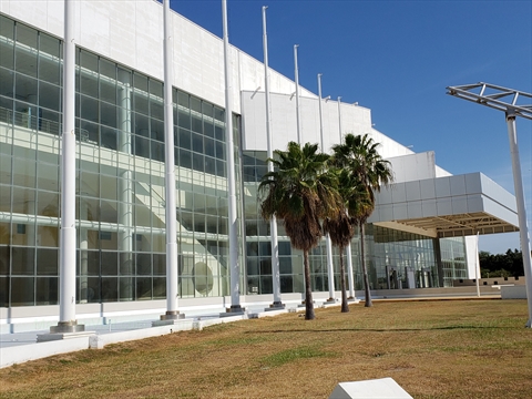 The modern, multi-story glass exterior of the Mazatlán International Center