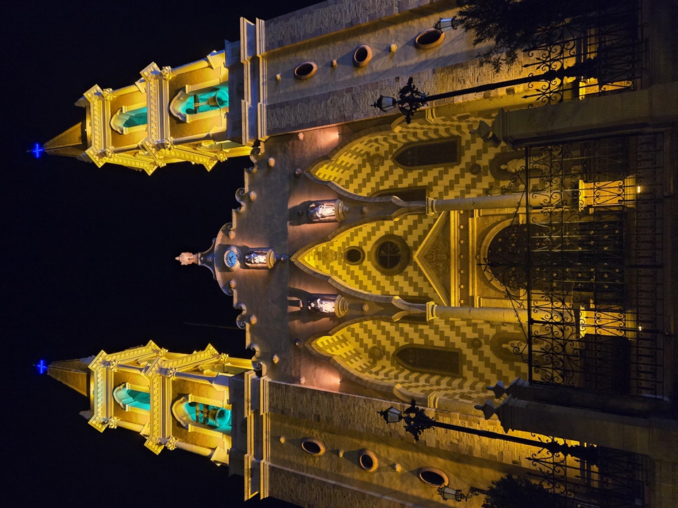 Towering perspective showing the illuminated cross points reaching into the dark night sky