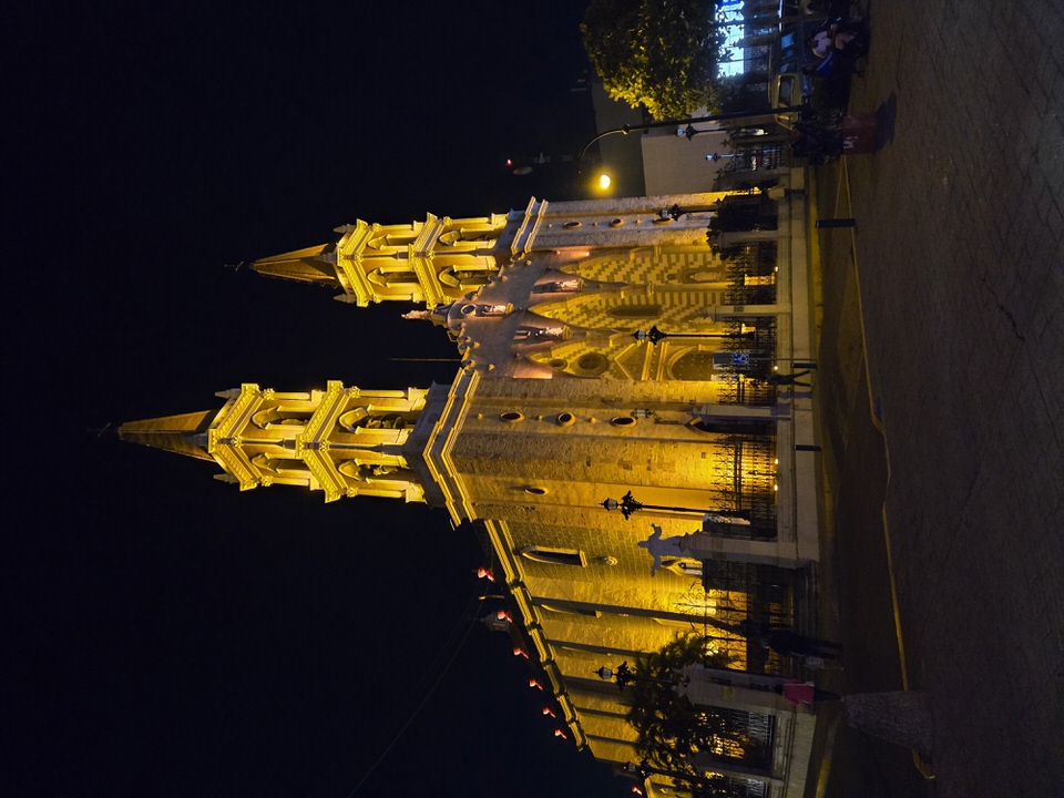 Cathedral facade illuminated by ambient neon and golden spotlight fixtures