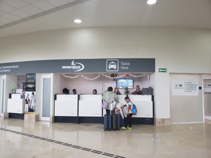 Official authorized taxi and shared shuttle booking ticket kiosks inside the arrival terminal lobby
