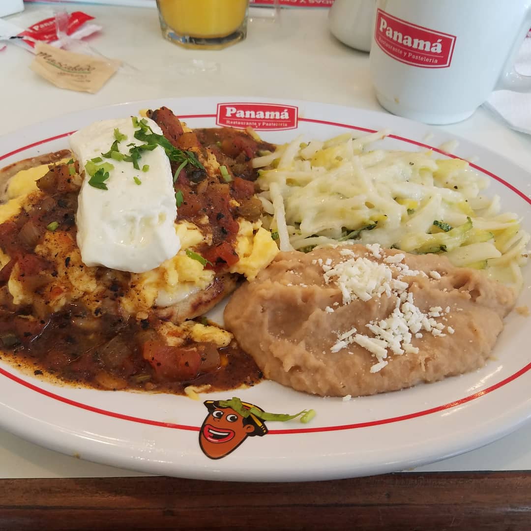 Traditional family breakfast table layout served inside Panama restaurant