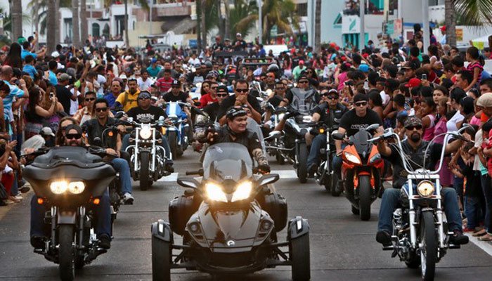 Motorcycle parade column traveling down the Malecon seawall boulevard