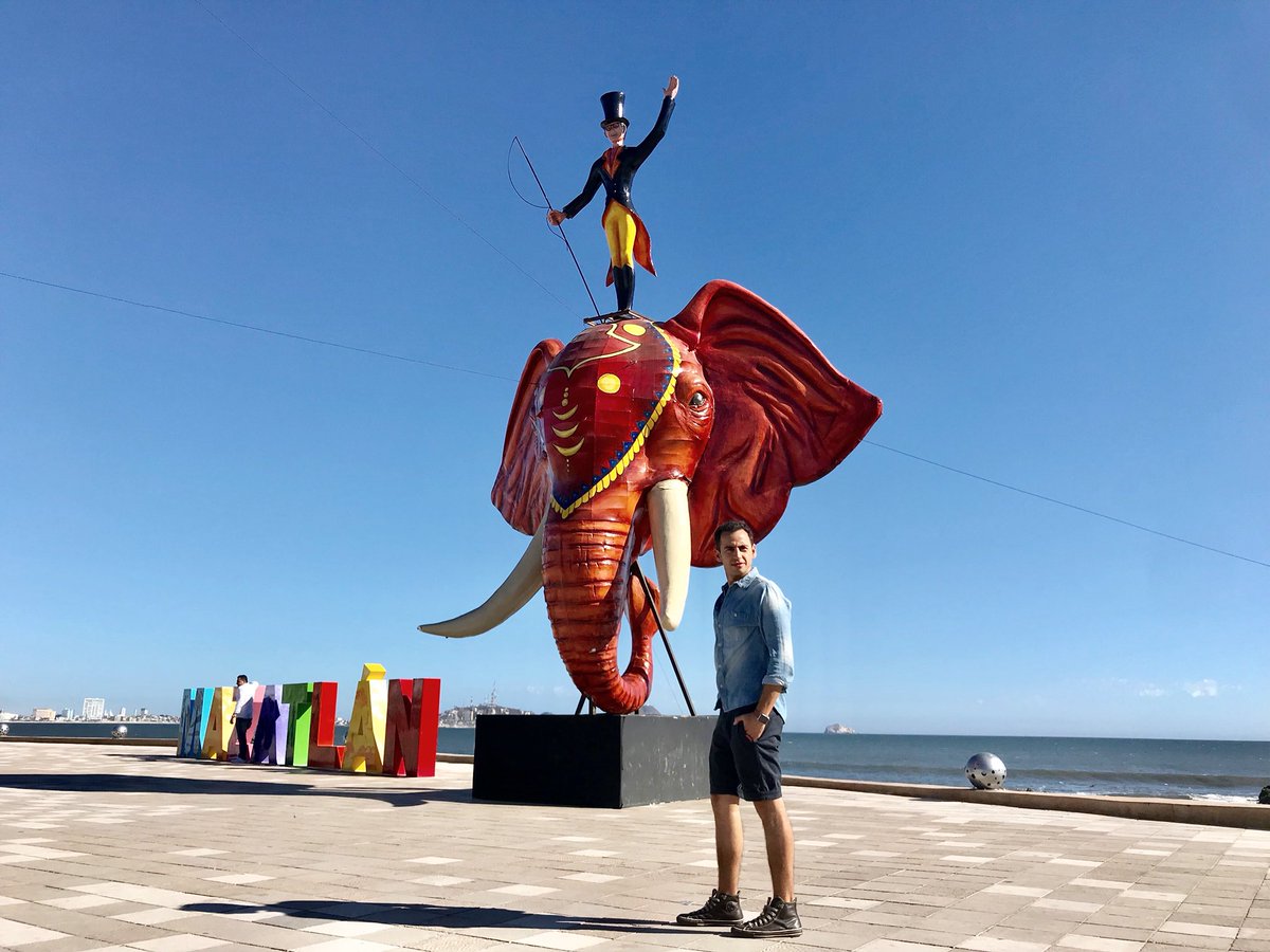 A towering structural paper mache puppet monument erected along the oceanfront boardwalk