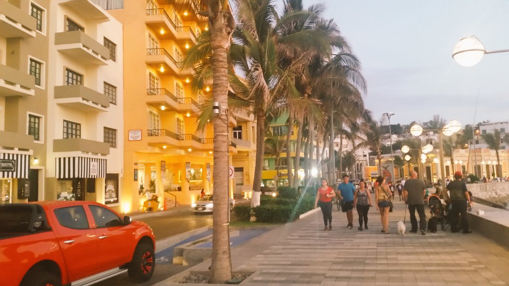 Evening sidewalk diners enjoying live music beside the seawall paths