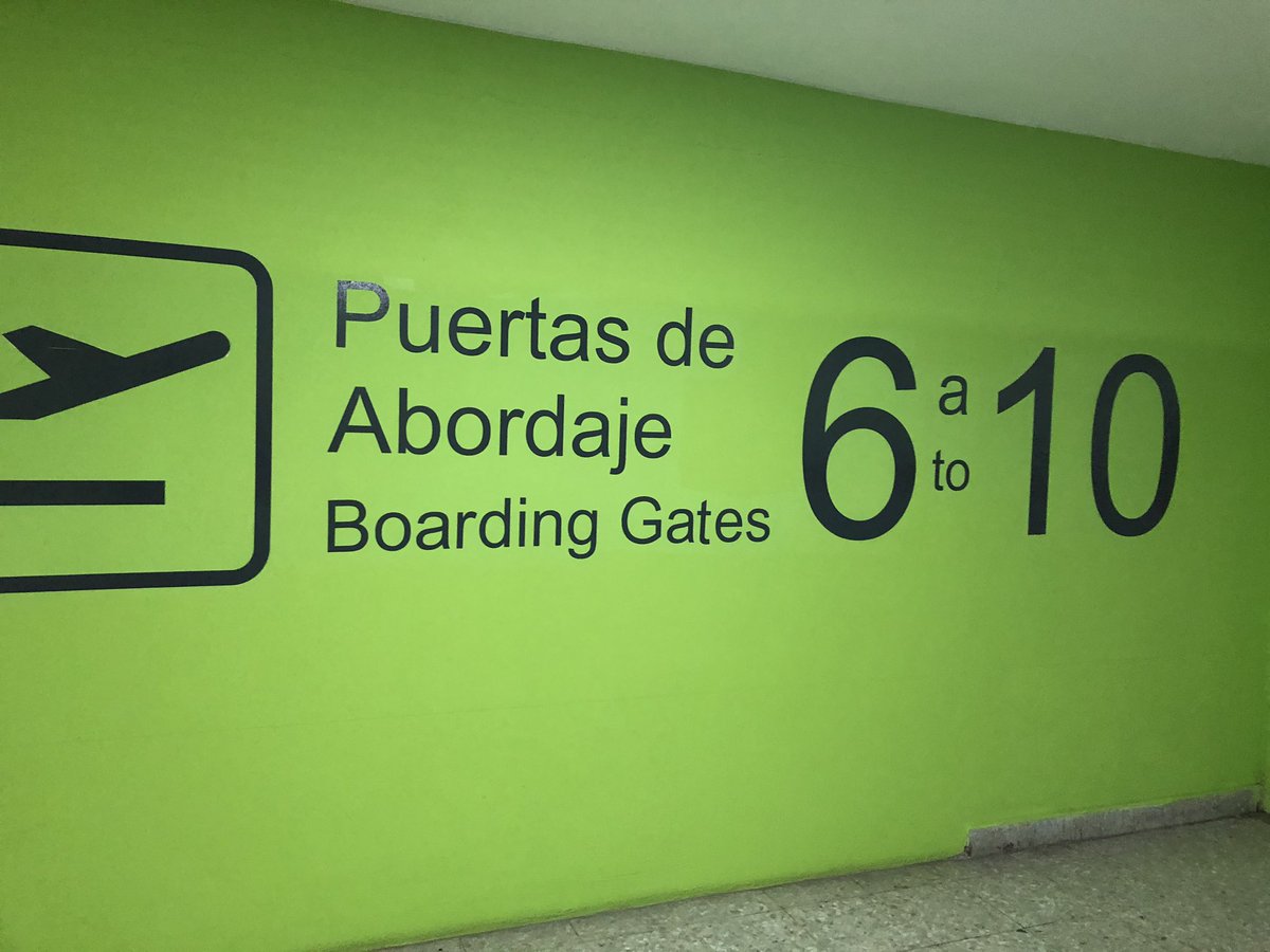 Clean modern upper level departure lounge gates and seating rows inside MZT airport