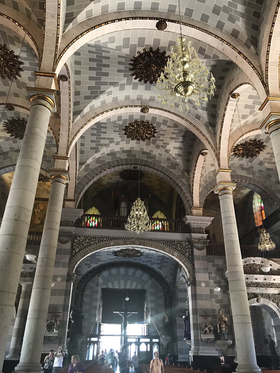 The high vaulted ceilings and historic crystal chandeliers lining the main sanctuary aisle
