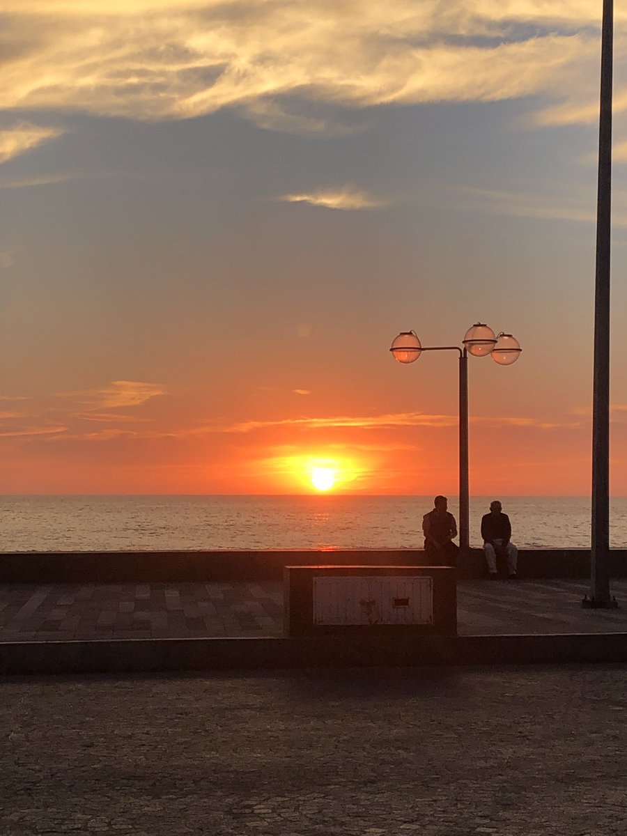 Vibrant warm sky colors reflecting off the waters along the main Malecón seawall walkway