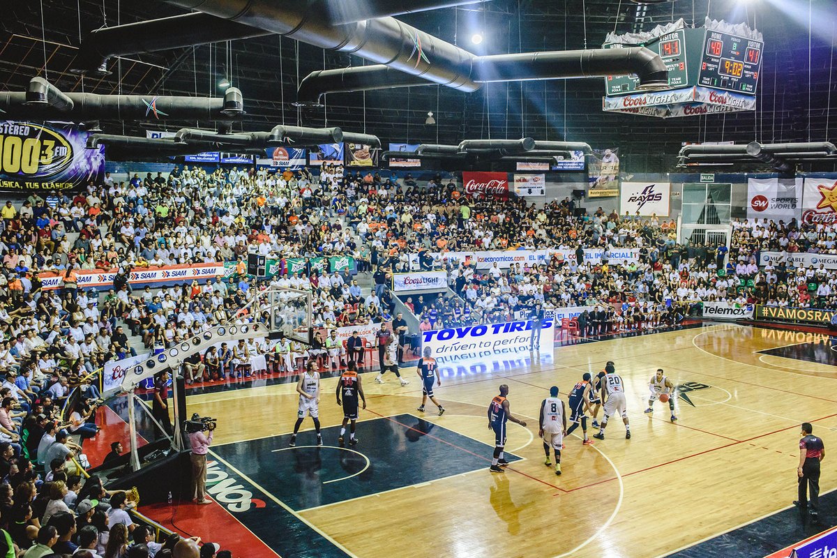 Professional basketball game action underway inside a covered sports arena