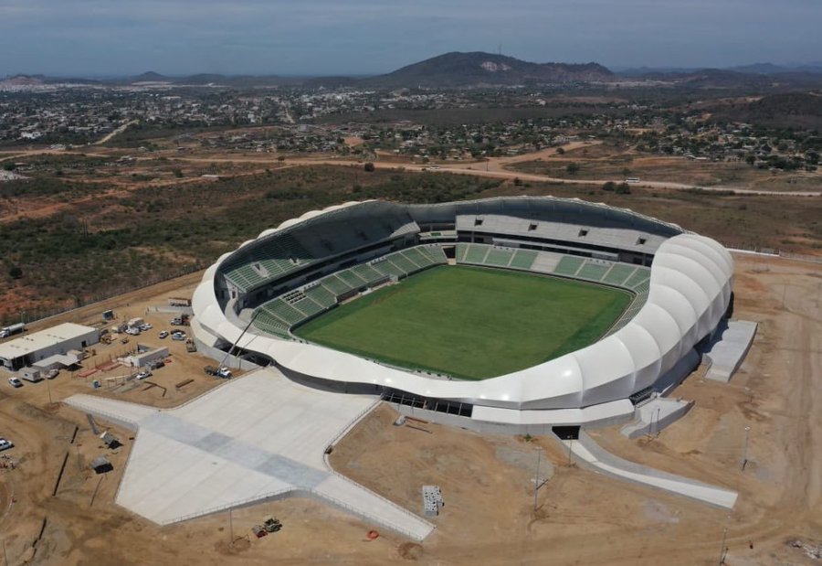 The futuristic curved white exterior structure of Estadio El Encanto in Mazatlán, Mexico