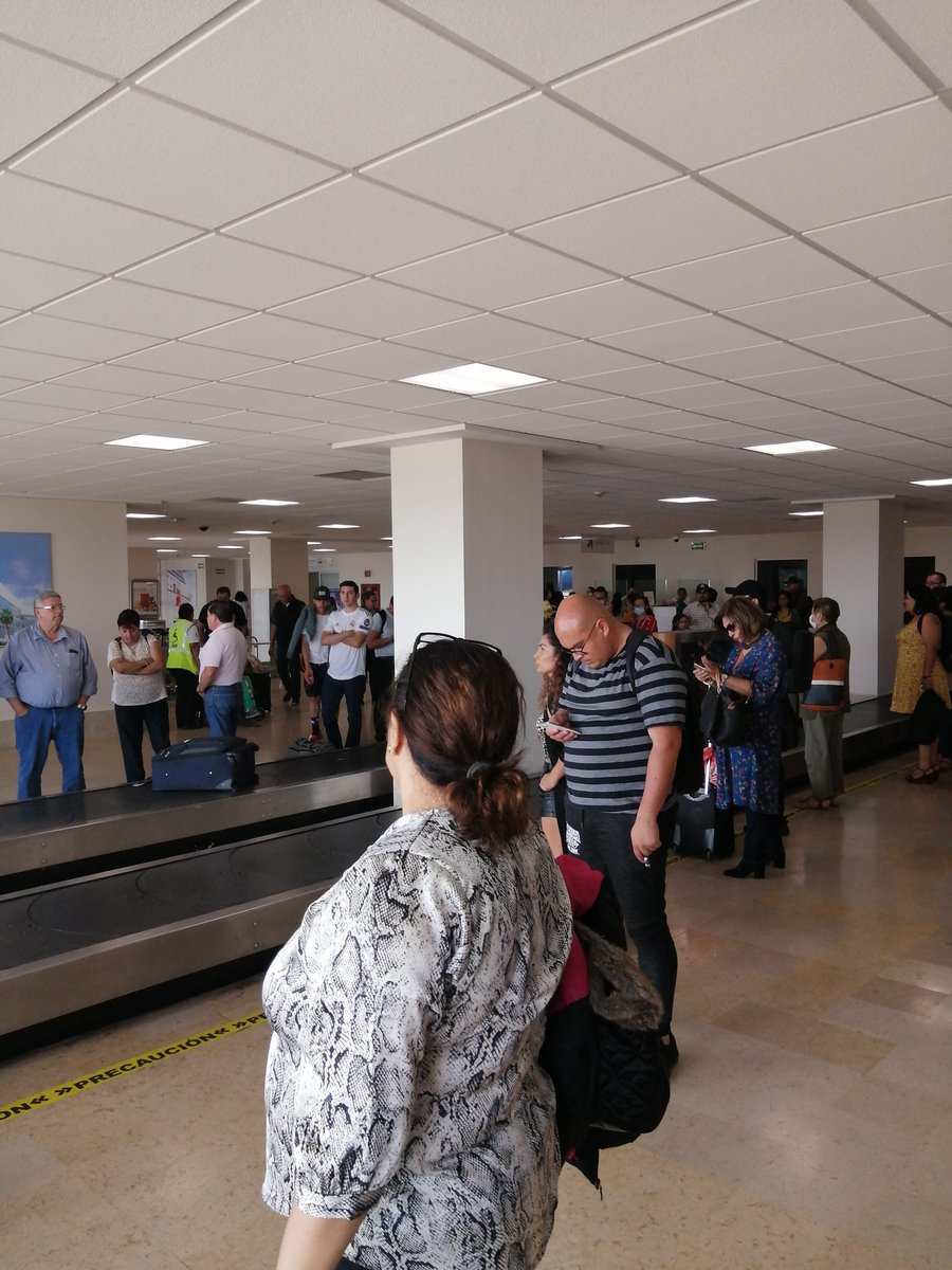 The central baggage claim room showing the automated luggage carousels at MZT
