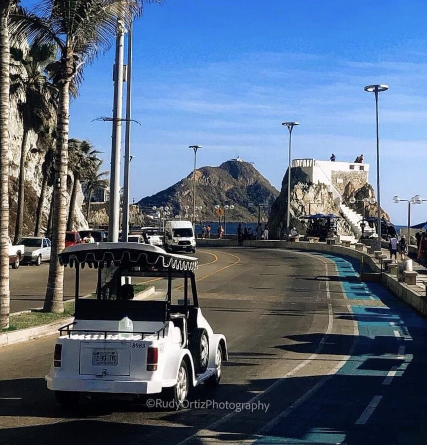 The winding coastal seawall of Paseo Claussen contouring around the rocky cliffs