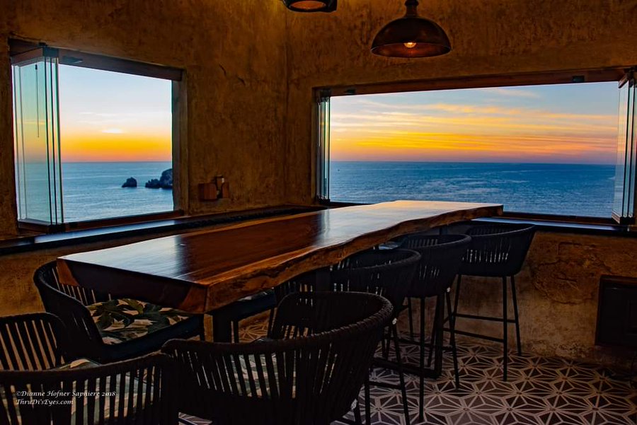 The elegant open air Sky Bar lounge terrace overlooking the ocean cliffs