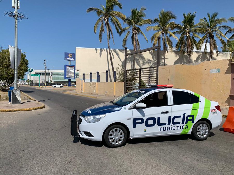 Highly visible white Tourist Police vehicle monitoring safety on the streets of Mazatlán
