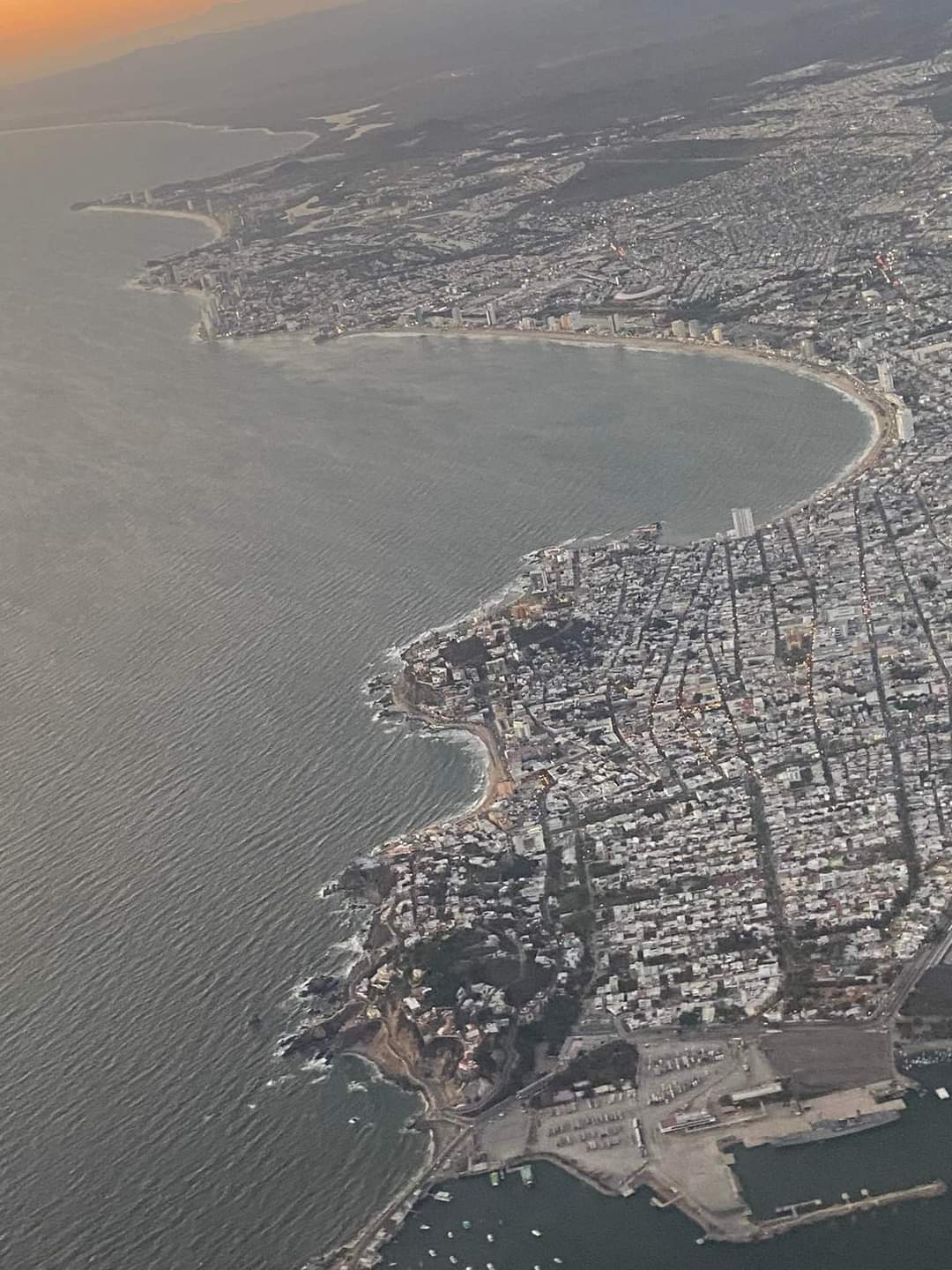 Scenic high altitude aerial drone overview tracking the coastline curves of Mazatlán