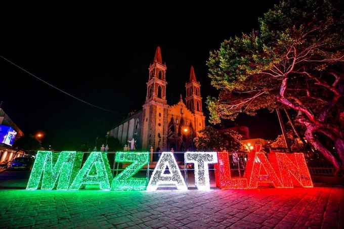 Artistic metal sign spelling out Plazuela República against old trees