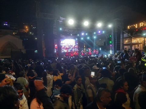 Packed oceanfront streets lit up by party stages during night events