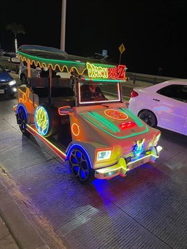 A colorful open air Pulmonía taxi illuminated by custom neon LED light arrays