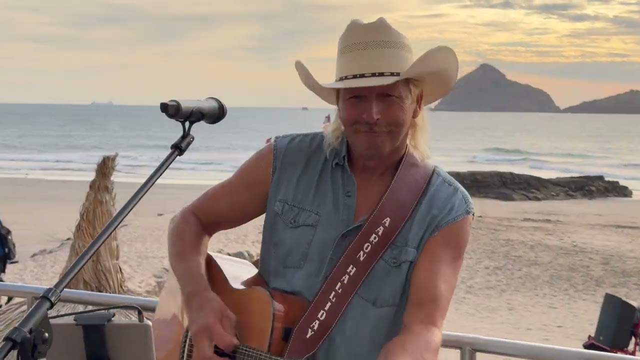 Aaron Halliday singing country hits live under the beachfront awning frame