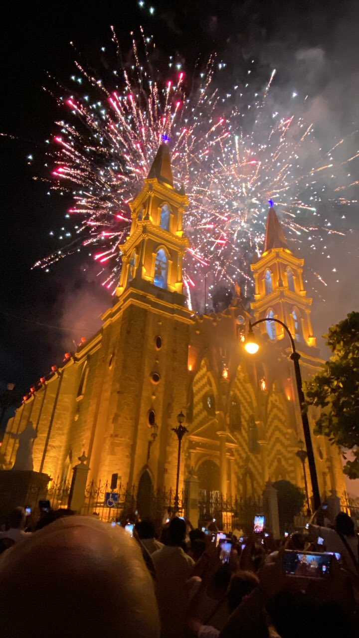 The twin gold spires of the cathedral beautifully illuminated at night by modern color changing LED fixtures