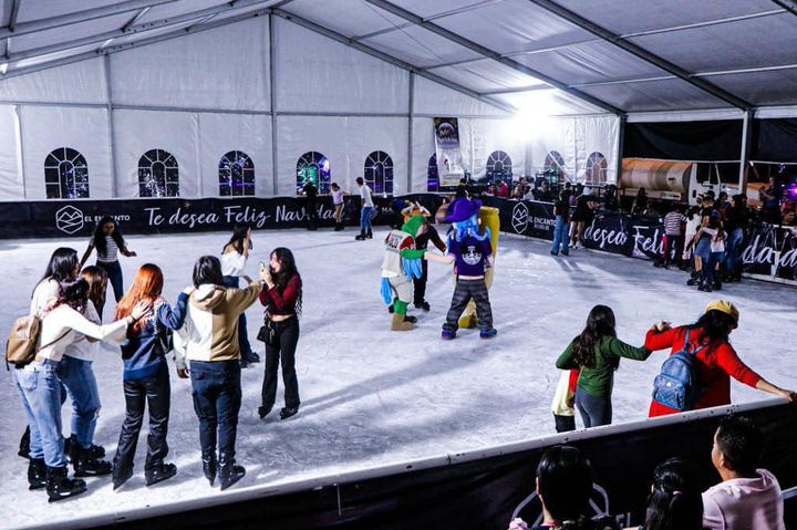 Cruisers and local kids skating inside the free holiday ice rink venue